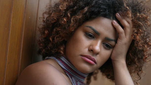 istock Pensive Brazilian woman thinking close-up face 1360344817