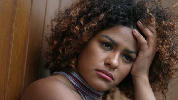 istock Pensive Brazilian woman thinking close-up face 1360344837