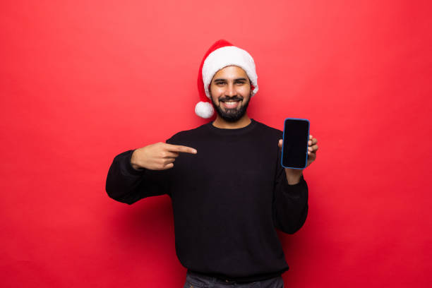 istock Young man pointed on phone screen on red background 1360346615