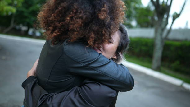 istock Friends embrace, two women hug, diversity concept 1360349763