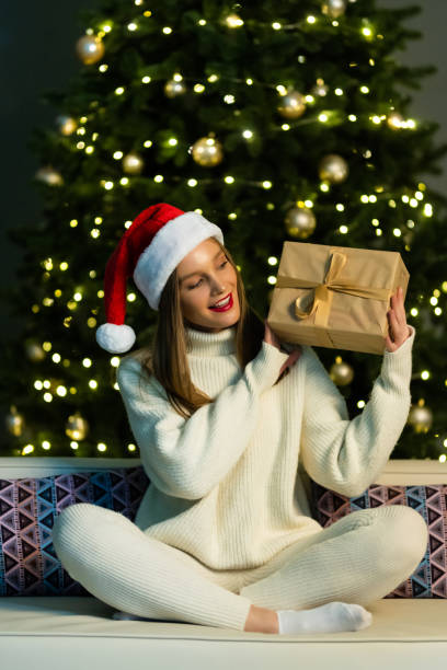 istock Happy Surprised Woman opening Gift box at home. Christmas Tree 1360350934
