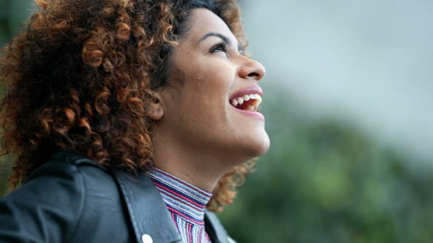 istock Overjoyed woman looking at sky with excitement and success 1360351152