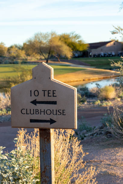 Golf course directional sign to tee and clubhouse Sign on golf course showing direction to clubhouse and start of 10th tee country club stock pictures, royalty-free photos & images