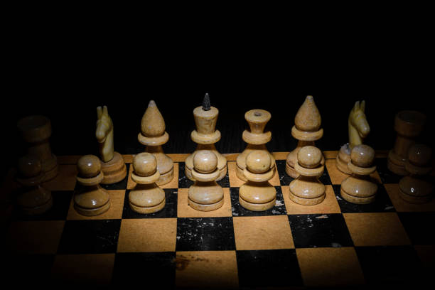 istock Wooden chess pieces on a wooden board. 1360352231