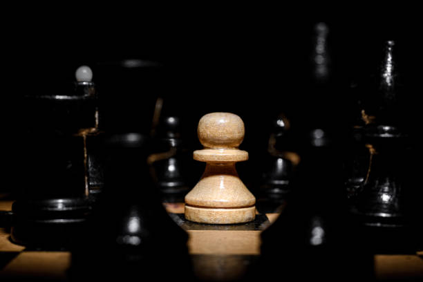 istock Wooden chess pieces on a wooden board. 1360352302