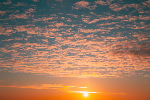 6K 5K 4K Sunset Cloudy Sky With Fluffy Clouds. Sunset Sky Natural Background. Dramatic Sky. Sunset In Yellow, Orange, Pink Colors. Day To Night Transition.
