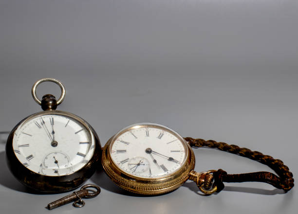 istock Two vintage pocket watches with key 1360352598