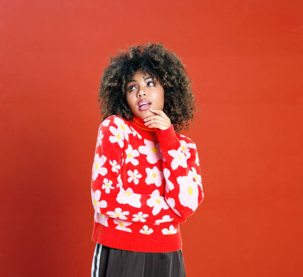 istock Surprised young woman against red background 1360352911