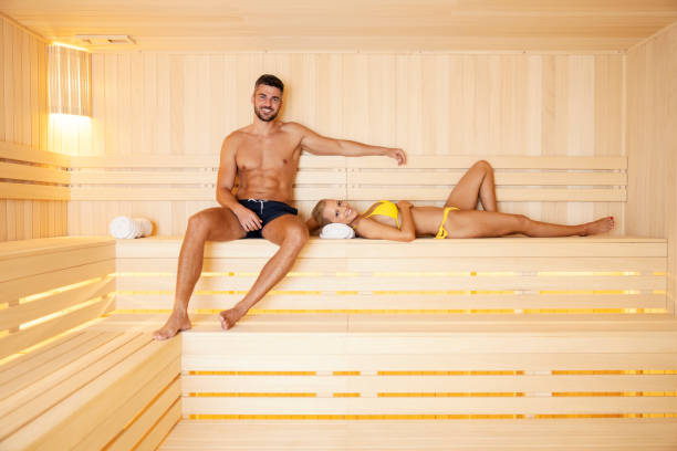 wellness, healthy life, and spa. a happy couple relaxing at spa center at weekend in a hot sauna. - health spa spa treatment couple heterosexual couple imagens e fotografias de stock