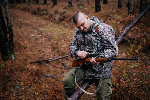 istock The hunter prepares the rifle 1360353939