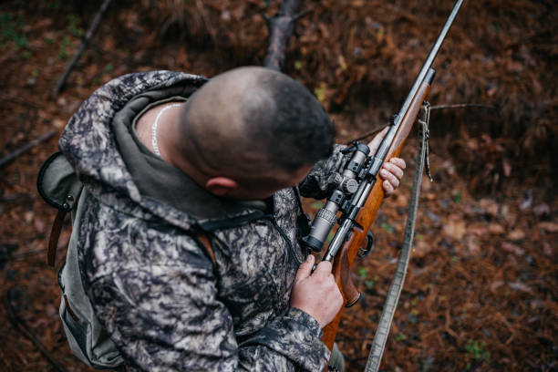 istock The hunter prepares the rifle 1360353985