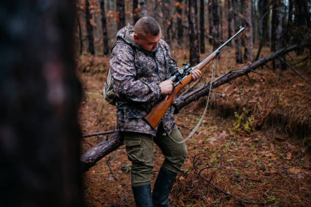 istock The hunter prepares the rifle 1360354117