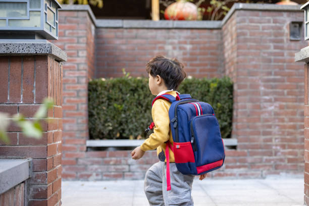 istock A little boy coming home from school 1360354132