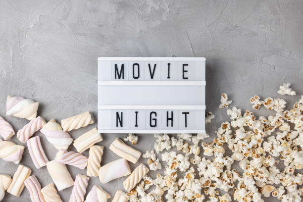 istock Text MOVIE NIGHT with popcorn and marshmallow. Movie snacks 1360356322