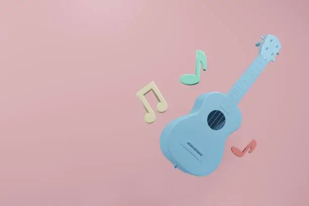 Photo of Acoustic classic guitar with music note on pink background.