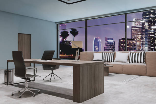 istock Modern concrete designer office interior with panoramic window and night city view, couch, furniture and decorative wall. Workplace and design concept. 3D Rendering. 1360358907