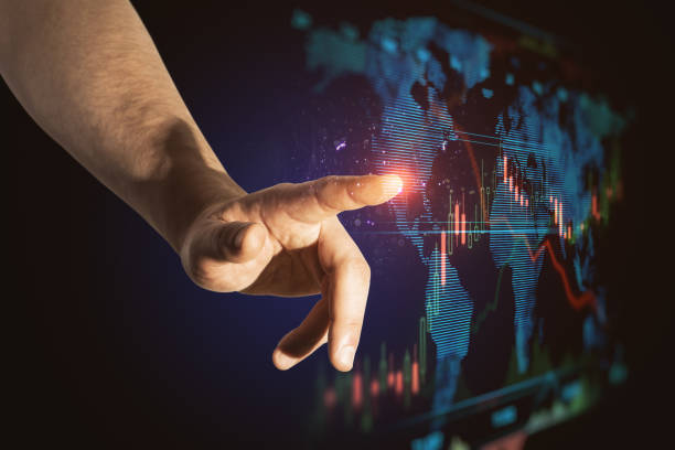 istock Close up of businessman hand pointing at abstract blue business forex chart and map interface on dark background. Trade, finance, analysis, growth, technology and innovation concept. 1360358920