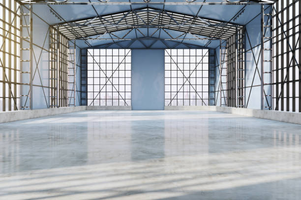 istock Bright spacious concrete empty hangar interior with sunlight, city view and window frames. Factory and industrial concept. 3D Rendering. 1360359122