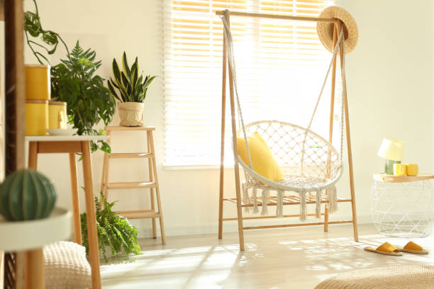 istock Comfortable hammock chair in stylish room. Home interior 1360359230
