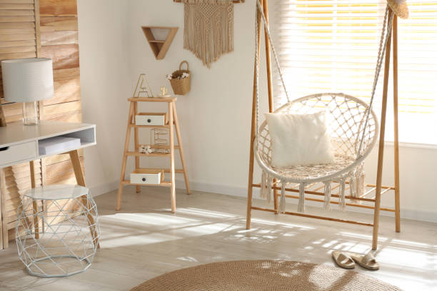istock Comfortable hammock chair in stylish room. Home interior 1360359753