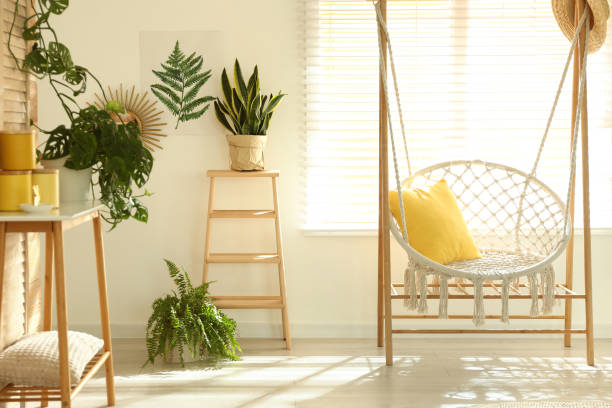 istock Comfortable hammock chair in stylish room. Home interior 1360359941