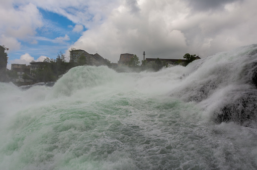 Closeup view of the cascading waters of the Rhine falls in Switzerland. Located between the cantons of Schaffausen and Zurich.