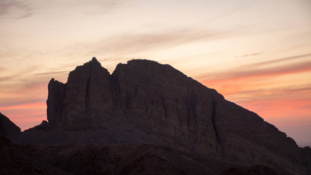 Large barren mountain at sunset Beautiful view of a large rocky mountain at sunset at Al Ain in Abu Dhabi, United Arab Emirates. jebel hafeet stock pictures, royalty-free photos & images