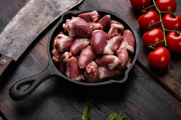 istock Raw bird hearts meat, on old dark  wooden table background 1360363480