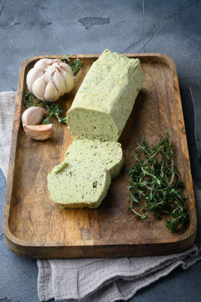 istock Fresh green herb butter, on gray stone background 1360363548