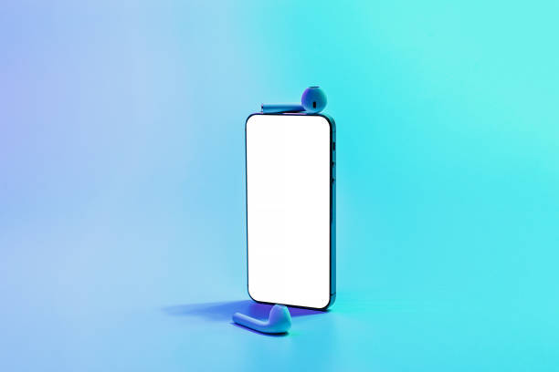 istock Smartphone mockup. Mobile smart phone technology blank screen. Mock up smart phone device, audio headphones equipment on neon gradient background. Information message content with clipping path. 1360363976