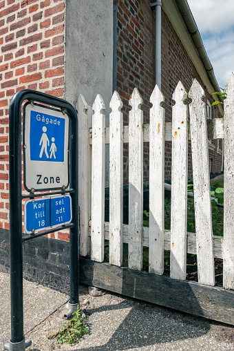 blue and white sign that indicates the pedestrian zone in danish language. 07/31/2021 -  6720 Fanø, Denmark