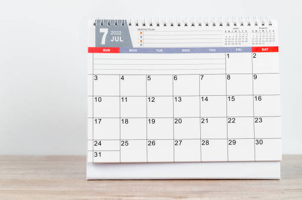istock July 2022 desk calendar on wooden table. 1360366237
