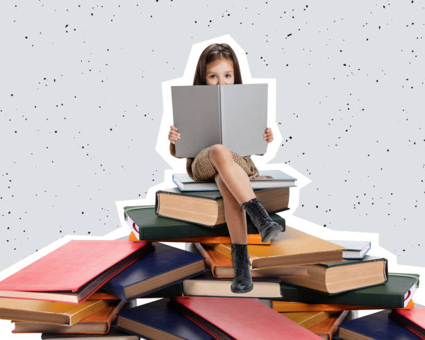 creative design curious little girl, child sitting on stack of books and reading isolated over gray background - humor book fun human age imagens e fotografias de stock