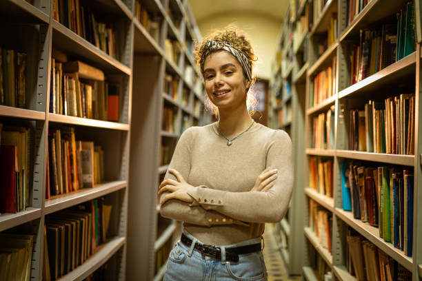 istock Smiling woman at the library 1360367162