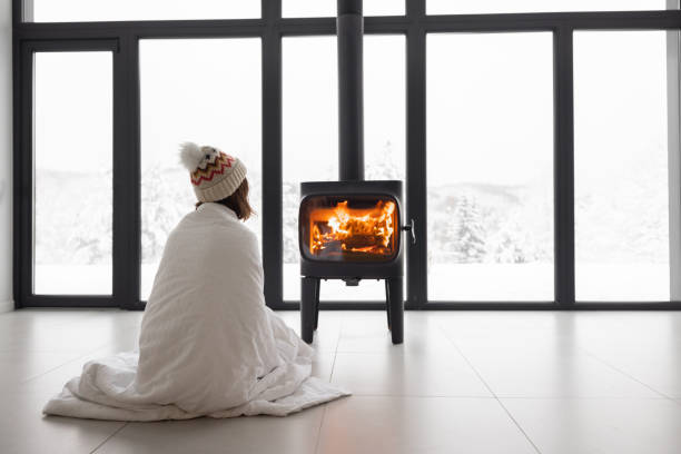 istock Woman at home with burning fireplace during wintertime on nature 1360367449