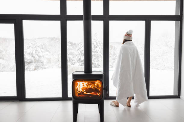 istock Woman at home with burning fireplace during wintertime on nature 1360367457