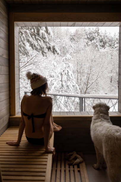 istock Woman resting in sauna with view on snowy nature 1360367636