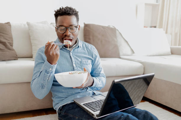 istock Men working from home and enjoys a short break eating a salad. 1360369725