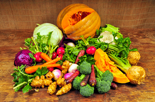 Healthy food background with copy space. Assortment of fresh vegetables on wooden background. Harvest of vegetables.