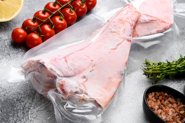 istock Orange roughy frozen pack fish meat, with herbs, on gray stone table background 1360371540