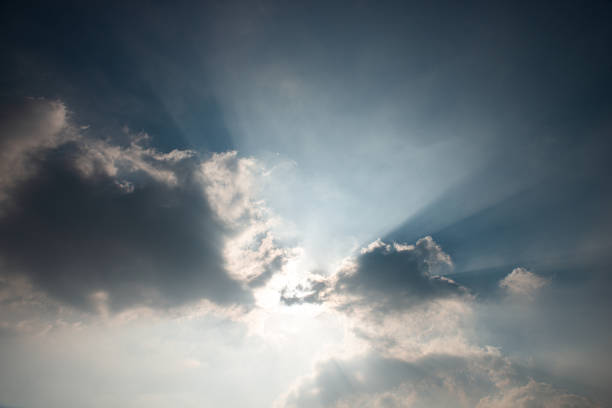 istock The sun shines through the rays of the clouds 1360372958