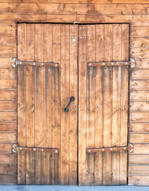 istock Old wooden gate with metal hinges 1360373800