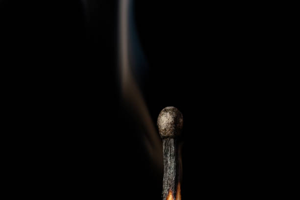 istock One lonely burnt match with some slight smoke against black background 1360375333