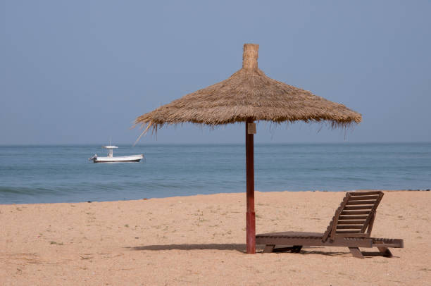 Saly beach in Senegal Landscape with a hammock and umbrella on Saly beach on the Senegal coast senegal beach stock pictures, royalty-free photos & images