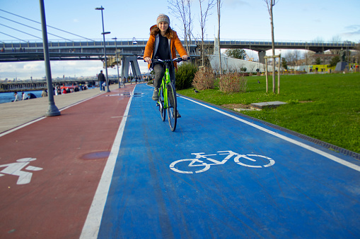 One person, women, copy space, bicycle lane, riding, looking at camera