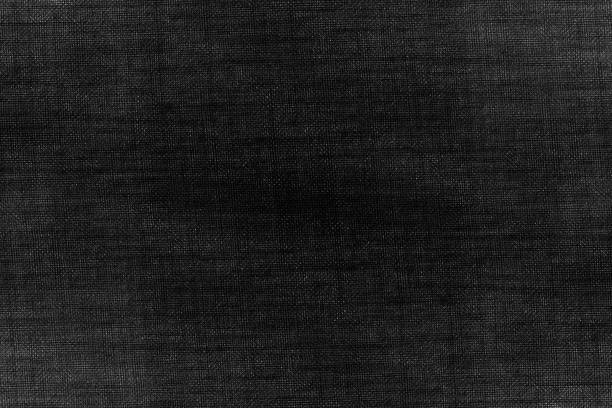 istock Abstract dark texture background of desaturated denim fabric 1360378679