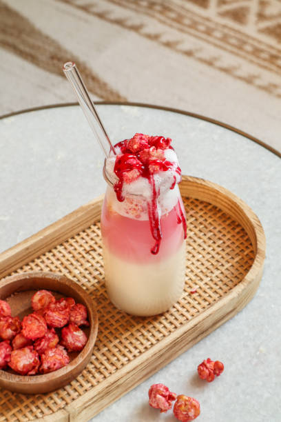 Pink milkshake with strawberry popcorn and berry sauce