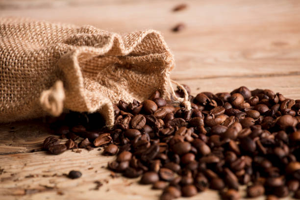 istock roasted coffee beans with raffia sack, on rustic wooden table 1360381510