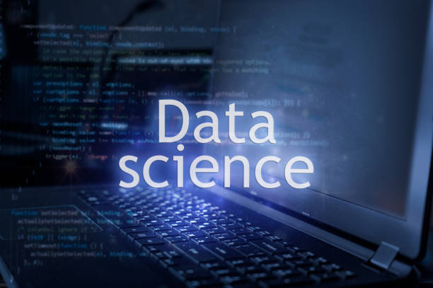 Data science inscription against laptop and code background. stock photo