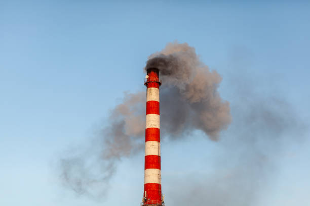 istock White thick smoke from the boiler room chimney. Industrial zone. 1360381670